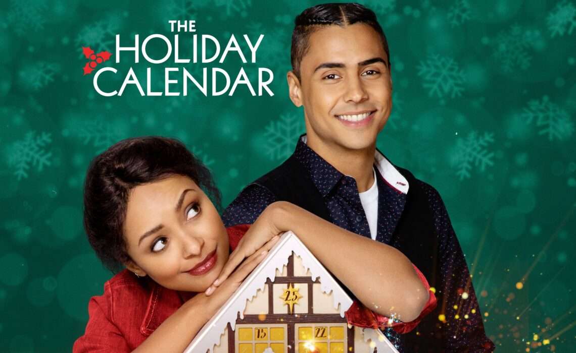 Poster for The Holiday Calendar featuring a woman leaning her chin on a wooden advent calendar shaped like a house, looking up playfully. Beside her stands a smiling man with his arm resting on the calendar. The background is a teal-green color filled with softly blurred snowflakes, and the title appears above them in white lettering with a small holly graphic