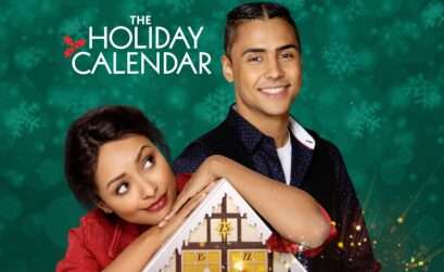 Poster for The Holiday Calendar featuring a woman leaning her chin on a wooden advent calendar shaped like a house, looking up playfully. Beside her stands a smiling man with his arm resting on the calendar. The background is a teal-green color filled with softly blurred snowflakes, and the title appears above them in white lettering with a small holly graphic