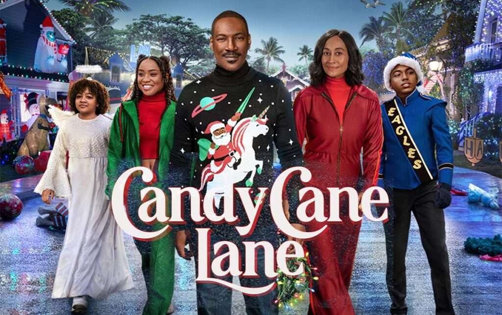 Poster for Candy Cane Lane featuring Eddie Murphy standing at the center in a black Christmas sweater decorated with Santa riding a unicorn. Beside him are four family members in festive outfits, including a girl in a white dress, a young woman in green, a woman in red, and a boy in a blue marching-band uniform. They are walking down a brightly lit, over-the-top Christmas neighborhood filled with decorations. The title ‘Candy Cane Lane’ appears across the bottom