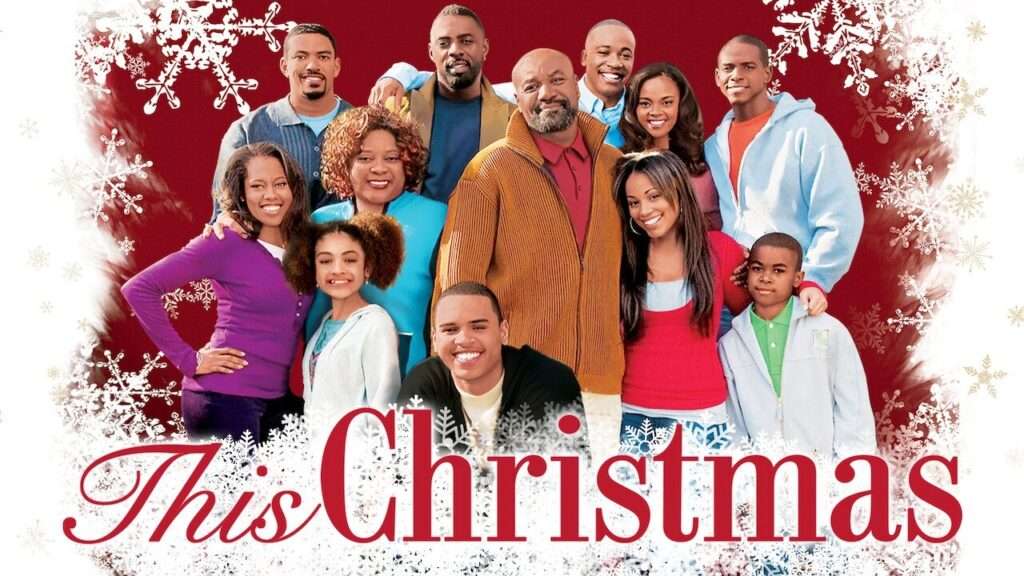 Poster for This Christmas featuring a large, smiling family gathered closely together against a deep red background decorated with white snowflakes. At the center is an older man in a mustard cardigan with family members of all ages surrounding him—teens, adults, and children. The title ‘This Christmas’ appears in elegant red script across the bottom.